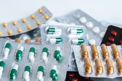 Colorful antibiotic drug capsule pills in blister package.