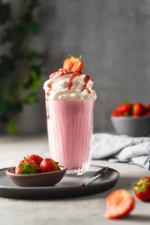 Strawberry milkshake with cream and berries. 