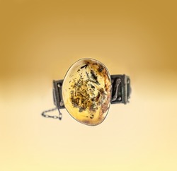 Beautiful silver bracelet with amber on bright gradient background