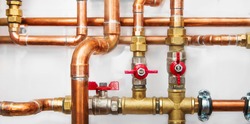 Copper valves and pipes on a white wall