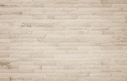 Empty background of wide cream brick wall texture. Beige old brown brick wall concrete or stone textured, wallpaper limestone abstract flooring, Grid uneven interior rock. Home decor design backdrop.