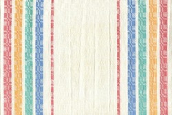 Kitchen linen towel with green, red, blue, white stripe. Natural fabric with multicolored stripes. Abstract background of simple fabric.