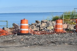 Large Orange Construction Barrels and Orange Striped Barricade for Traffic Control