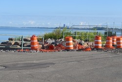 Large Orange Construction Barrels and Orange Striped Barricade for Traffic Control