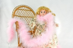 Blonde Hair Blue Eyed Doll With Pink Feather Boa and Classic Long Pearls