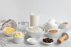 Ingredients for baking on a white background. Baking ingredients background. Ingredients for making dough, cakes, muffins, pies, side view.