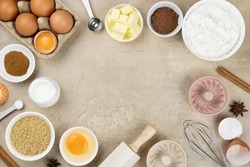 Frame of ingredients for baking. Ingredients for making dough, cakes, muffins, cookies. Baking ingredients: flour, sugar, eggs, spices, milk, chocolate, baking powder, whisk, rolling pin, muffin tins.