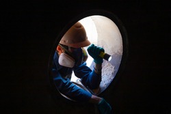 Workers take care safety of people working in confined spaces.