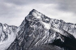 Big mountain peak with snow covered and overcast sky in Canada