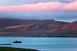Beautiful sunset over mountain range and cloudy on coastline in peninsula on summer at Iceland