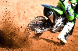 motocross racer accelerating in dirt track