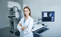 Experienced female radiologist standing near mammography workstation at radiology room of hospital. Mammography, mammogram