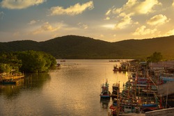 Fishing boats with sunset sky in fishing village, Ban Pak Nam Khaem Nu, Chanthaburi, Thailand.