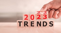 2023 trend concept. Hand flip wood cube change year 2022 to 2023