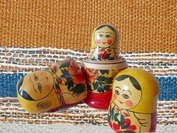 Matryoshka - Russian folding doll made of wood, inside which there are dolls of smaller size. Semenovskaya matryoshka is painted bright, with black hair, a handkerchief on her head.