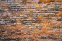 Red brick wall. Texture of old brown and red brick wall background. Fragment of red brick wall closeup. The structure of the background. Template for an inscription. Mockup for designs.