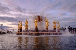 Fountain Friendship of peoples at sunset. One of the main symbols of the Soviet era. Sixteen female statues of the fountain represent the 16 Soviet republics. Moscow. Russia.