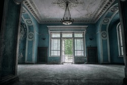 A beautiful room with shabby walls in an old abandoned house. Abandoned haunted manor. Ancient architecture and interiors.