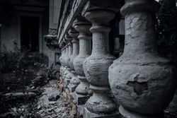 Old shabby columns in an abandoned manor. Scary haunted house. The ancient architecture of an abandoned house.