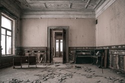 A beautiful old room in an abandoned building. Light from the windows. Beautiful doorway. Shabby walls. An old abandoned manor.