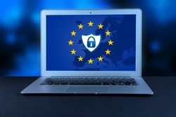 Lock icon and shield icon on the background of the EU flag, on the laptop screen. GDPR, General Data Protection Regulation, European Data Privacy Act. Copy space. High quality photo