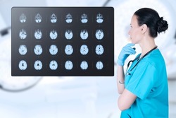 Doctor radiologist looks at the MRI, ultrasound, the child's brain in the CT scan room. Soft blurred background. Medical poster. High quality photo