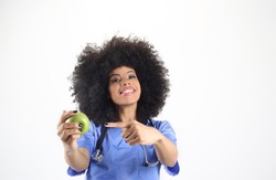 Female doctor with an apple in hand, afro woman white background