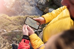 people using gps navigator app, forest hiking, couple on mountain at sunset