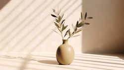 Modern summer minimal of olive tree branch in sunlight with long shadows on beige wall background, copy space interior lifestyle Mediterranean scene
