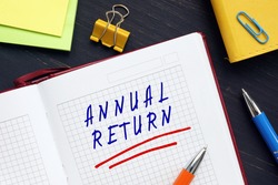Business concept meaning ANNUAL RETURN with sign on the piece of paper. An annual or annualized return is a measure of how much an investment has increased on average each year