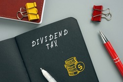 Business concept meaning DIVIDEND TAX with inscription on the page. AÂ dividend taxÂ is aÂ taxÂ imposed by a jurisdiction onÂ dividendsÂ paid by a corporation to its shareholders.