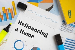 Financial concept meaning Refinancing a Home with sign on the page. 