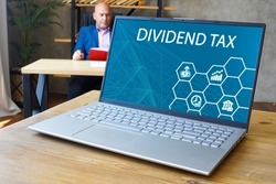 Business concept meaning DIVIDEND TAX with sign on the screen. 