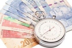 Time is money concept, stopwatch on South African money rand banknote