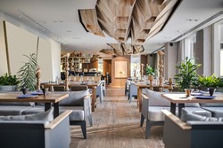 Restaurant in a modern style with textured walls and a parquet. There are gray sofas with tables, decorative wooden poles with birds, bar, plants. On ceiling there are wooden geometric constructions.