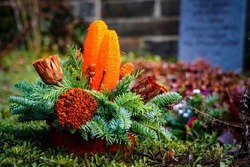 A flower arrangement on a grave site.