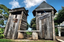 Classic country outhouse toilets with waiting area provided