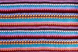 Crochet texture of colored striped knitted fabric