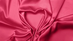 Viva Meganta toned red fabric atlas. Pink silk satin texture. Abstract background wallpaper Valentine's Day, February 14th. Twisted folds cloth heart shape sign. Trendy color of the year 2023. 

