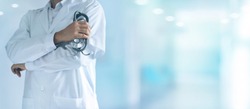 Medicine doctor with stethoscope in hand standing confidently on hospital background, healthcare concept.
