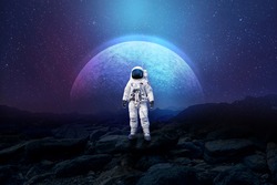 Astronaut on rock surface with space background ,astronaut walk on the moon wear cosmosuit. future concept