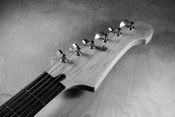 Black and white picture of electric guitar head