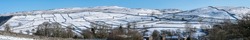 Snow covered Yorkshire Dales National Park winter panorama under a blue sky