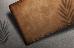 Logo mockup on leather brown wallet On a brown background with shadows