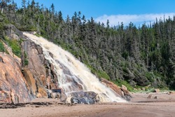 Beautiful panorama of the Grand-Sault Waterfall flowing into the Saint-Lawrence river in La Minganie, Quebec, Canada