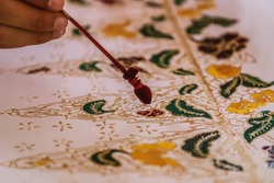 Process of making Thailand batik. It's a handmade artwork and one of the country's heritage, produced by technique of wax-resist dyeing applied to fabric.
