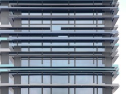 Double exposure of modern architecture. Hi-tech building with parallel moldings over glass wall. Minimal exterior with framed windows of structural glazing. Linear geometric pattern. Parallel lines.