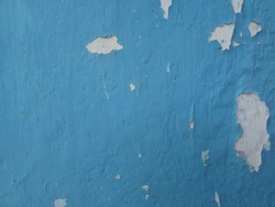 the cement walls are broken blue paint and peel off the paint