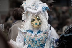 Venetian mask. Day of the Graff of May. Venetian mask. People in festival costume with mask at Venice carnival in Italy. Carnival costumes and masks Venice