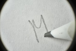 Macro Hand pencil Letter M.